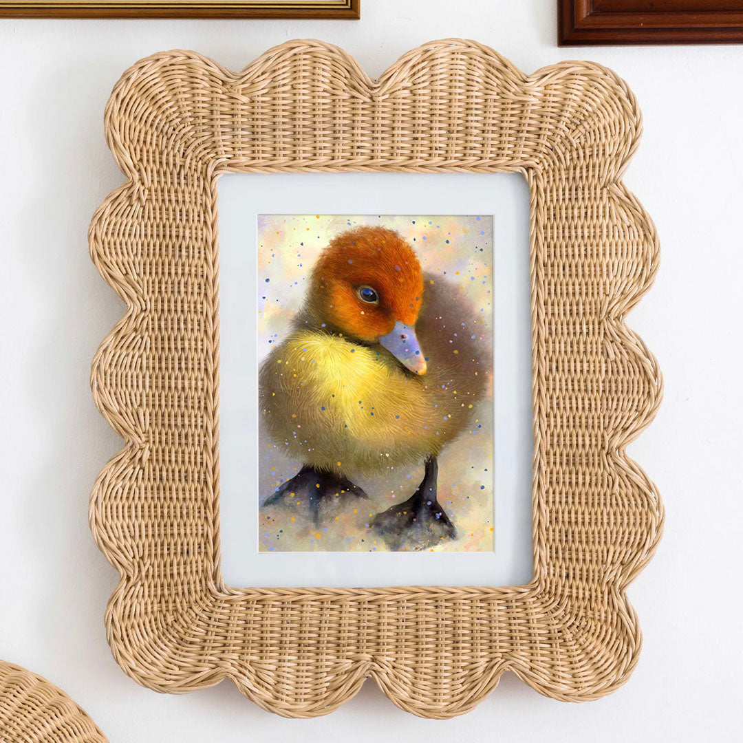 Postcard art of a cute little yellow duck with a red head and a blue beak with a lot of details, framed on a wall.